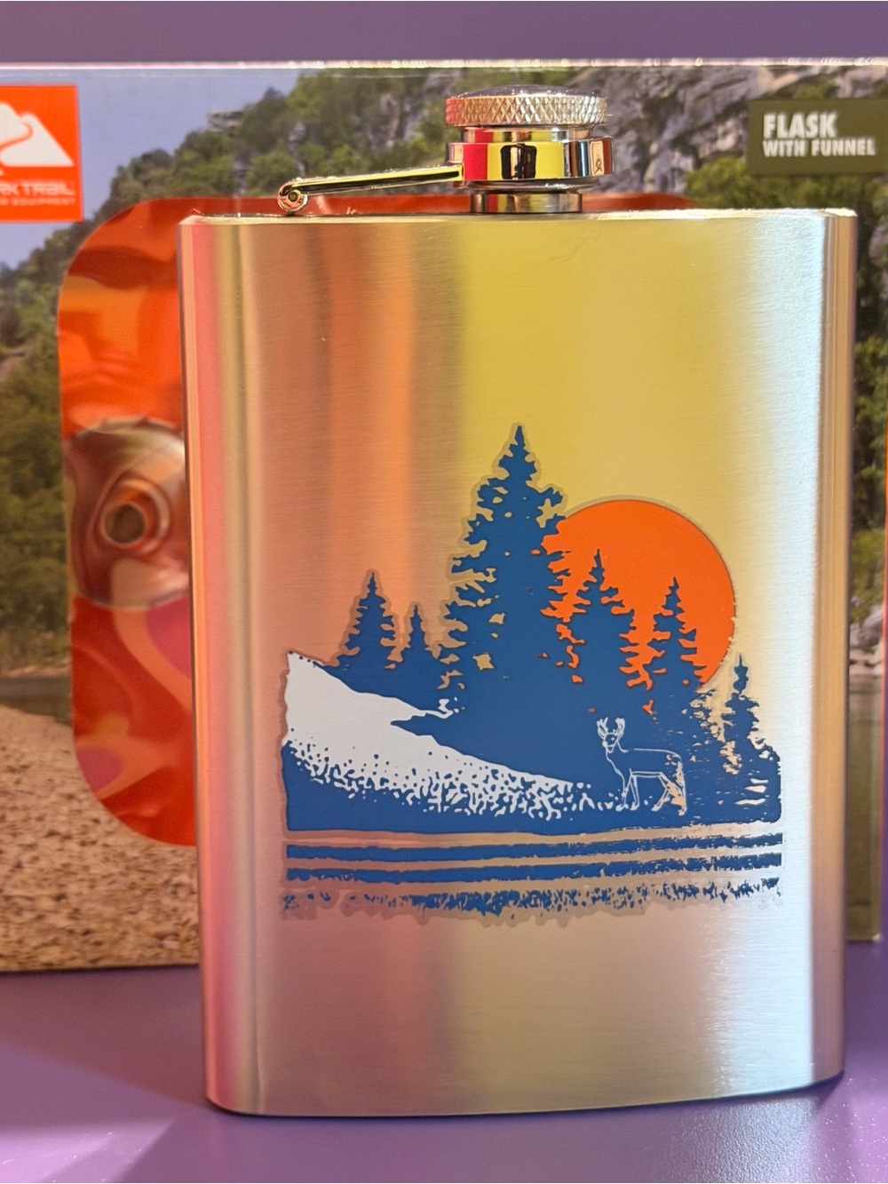 Ozark Trail Silver Hip Flask with Blue Forest and Orange Sun Design